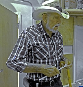 A man runs fingertips along a a notched aluminum tue