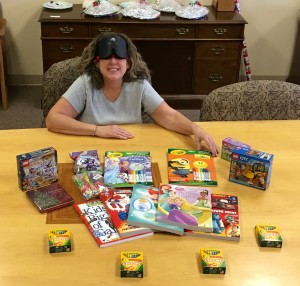 A smiling woman displays items she is about to deliver 