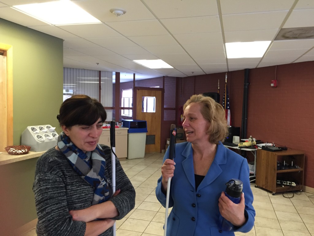 two women talk and smile in the meeting room