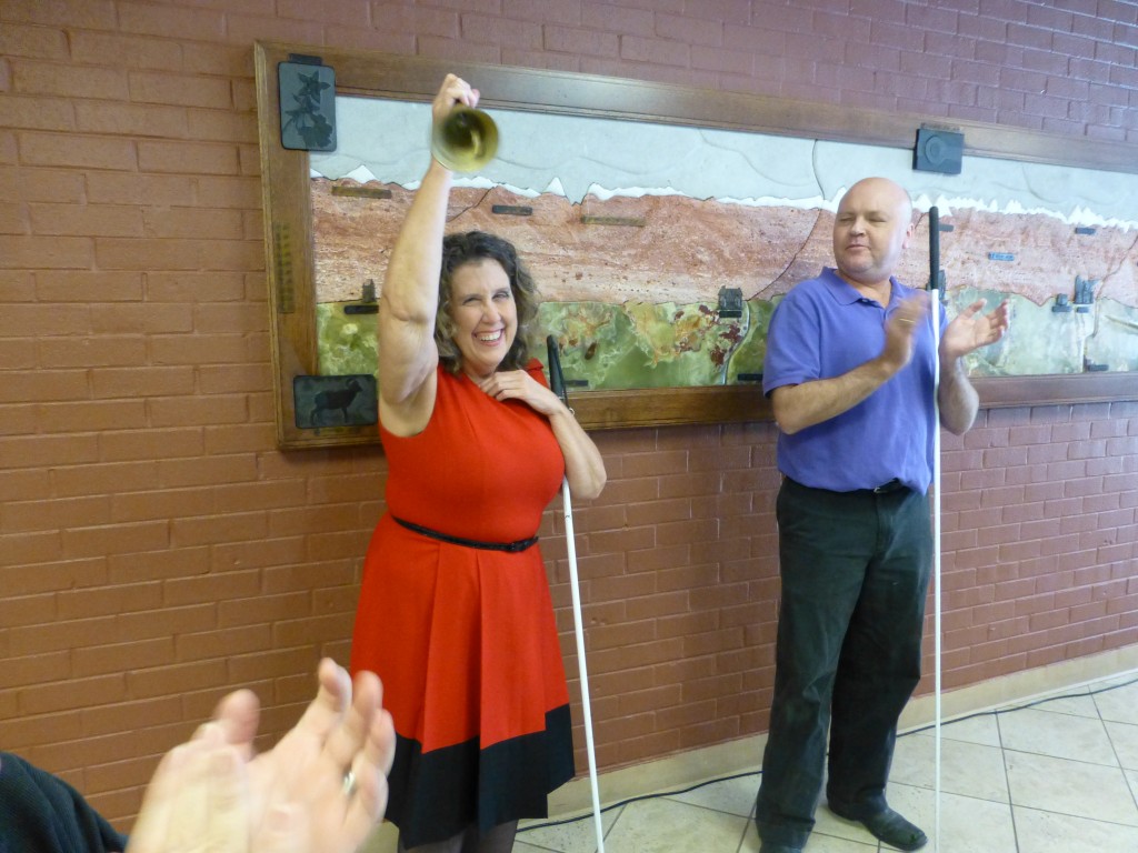 A woman gives her Freedom Bell a vigorous ring