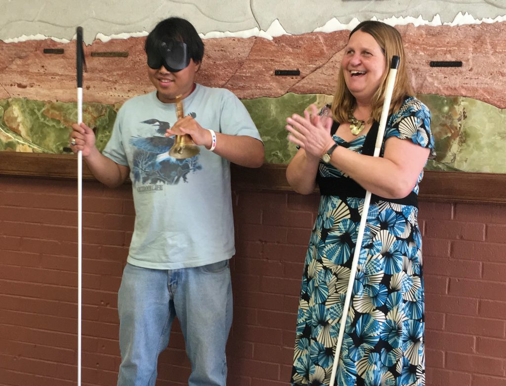 Joey grins as he rings his Bell of Freedom