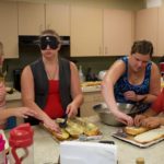 two counselors and two students working on slices of garlic bread