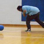 Young man demonstrates a spin throw in Goalball