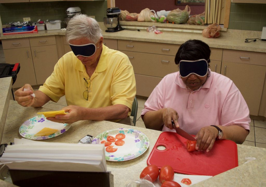 A man and woman prepare food in the kitchen