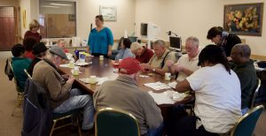 A group of a dozen seniors along with CCB staff work on making sugar scrub