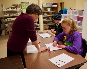 Ann works with C.G and Jackson on perspective drawing