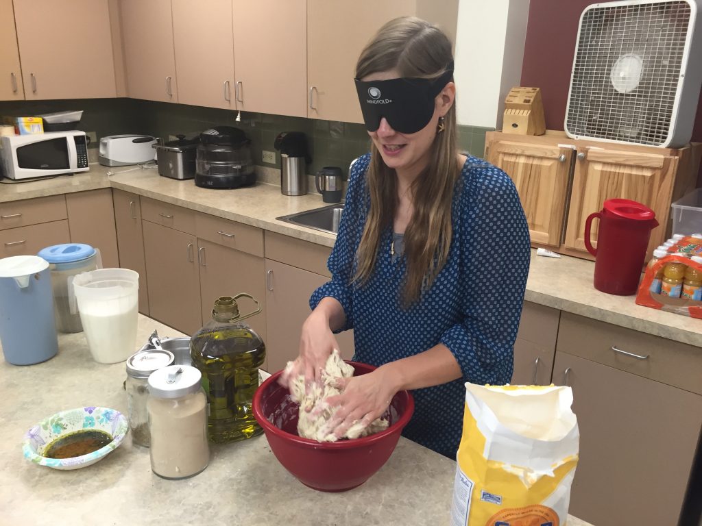 Tabea kneads dough with both hands