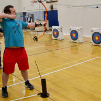 Zach H. takes aim with his Bow in Archery Class