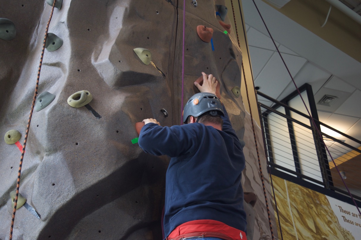 David D. reaches for a handhold as he progresses up the climbing wall