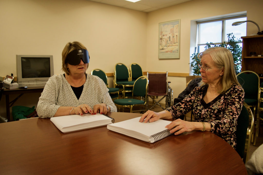 Holly and Janet reading Braille Books