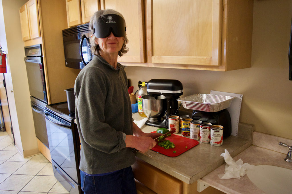 Sally wears sleepshades while chopping Bell Peppers