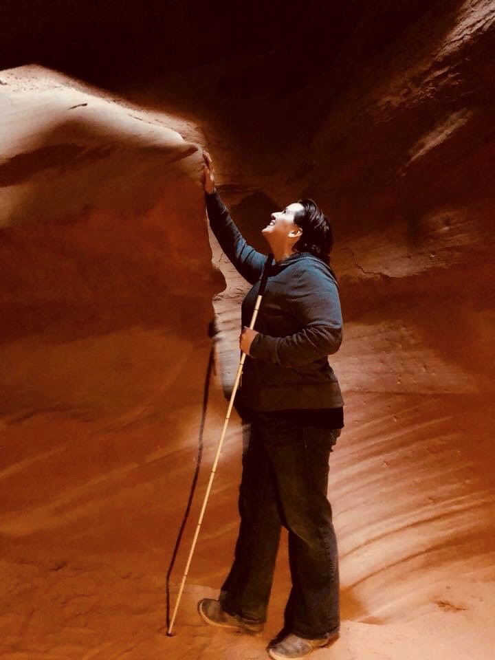 Libby with her cane exploring the wind and water whipped canyon walls at Antalope Canyon Arizona