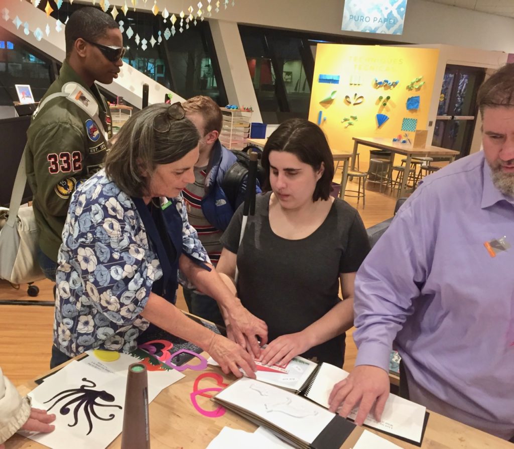Ann explores tactile art with a group of blind students at the Denver Art Museum