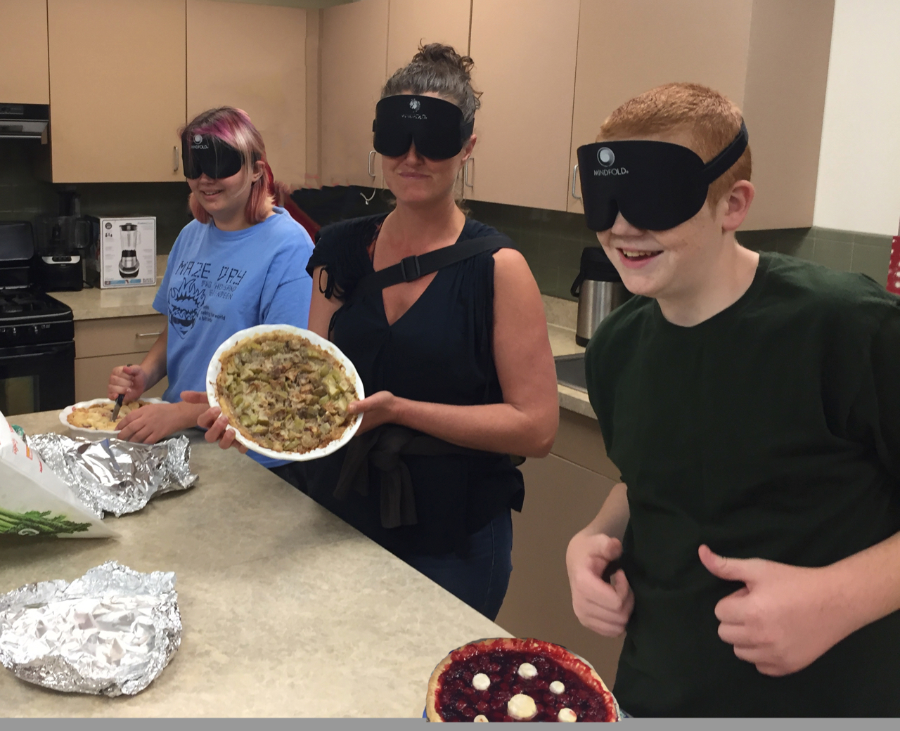 Adia, Melissa and Tyler (with 2 thumbs up) showing off their pies