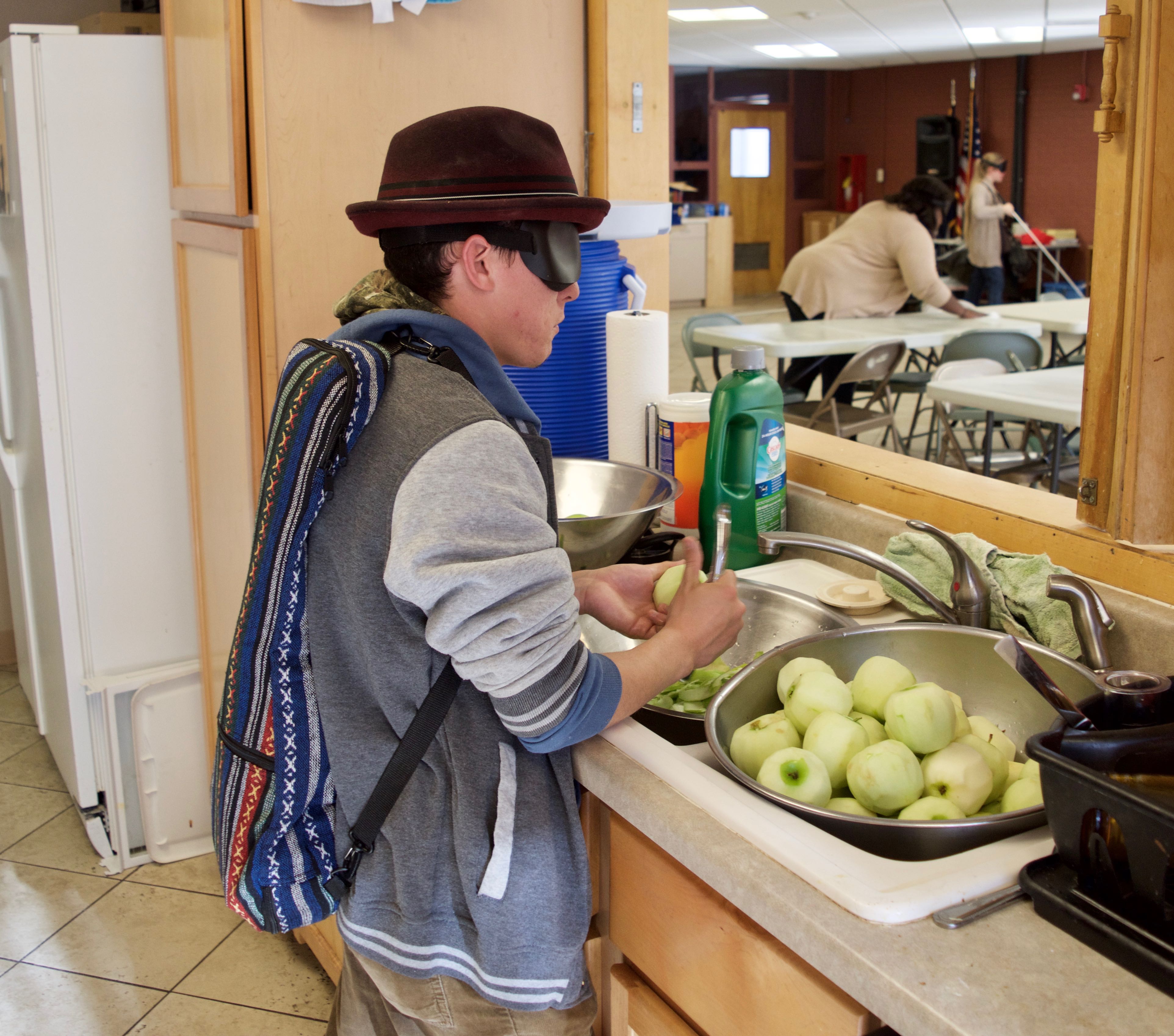 Alejandro peels apples for baked apple dessert for his Graduation Meal