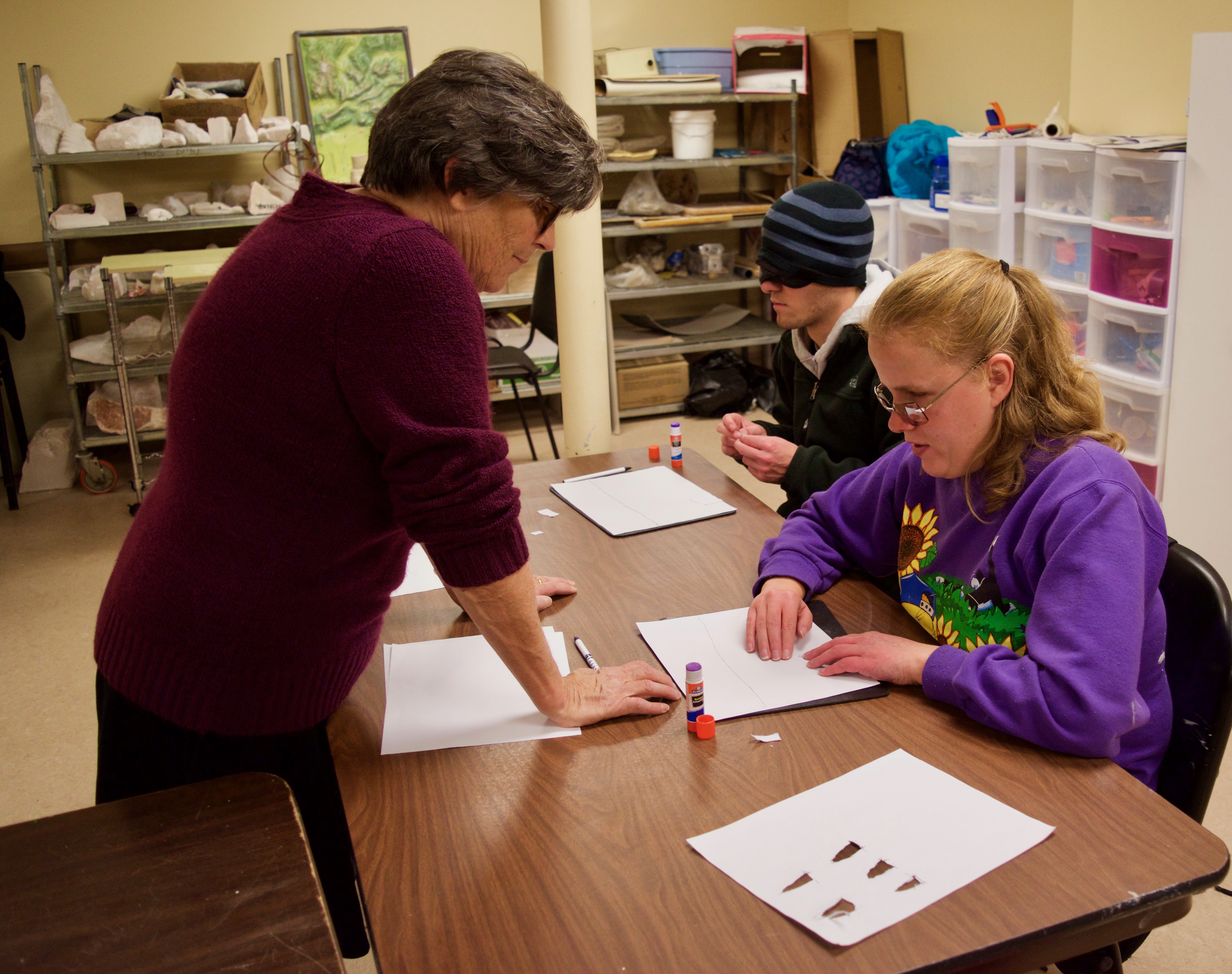 Ann works with C.G. and Jackson on perspective drawing