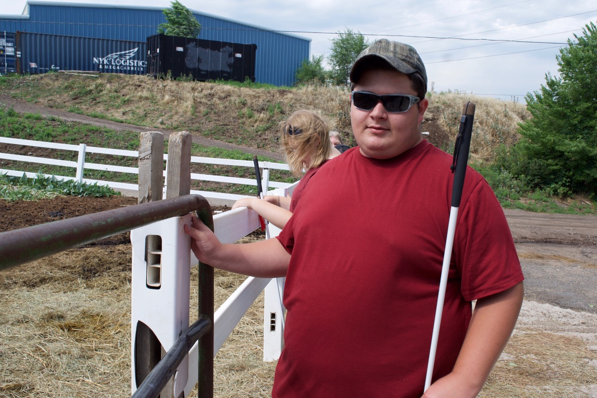 Brett inspects fence posts that need to be replaced at The Right Step Horse Ranch