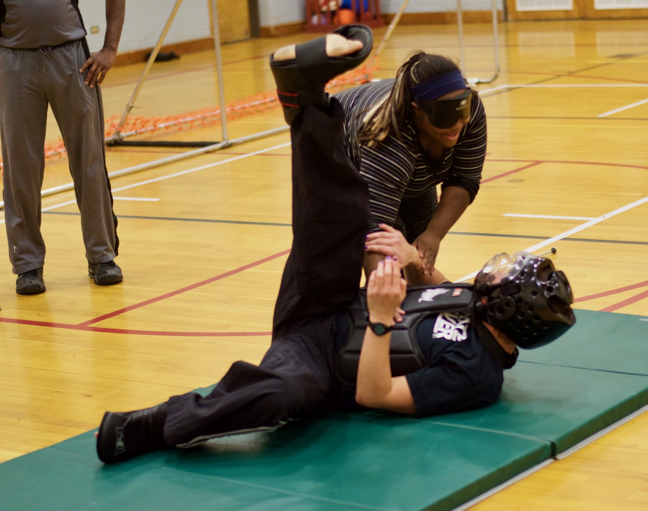 Brittany throws Travis flat on his back on the mats