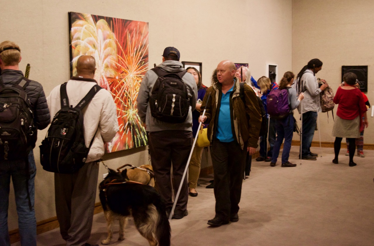 CCB students take turns exploring numerous tactile art pieces on the walls