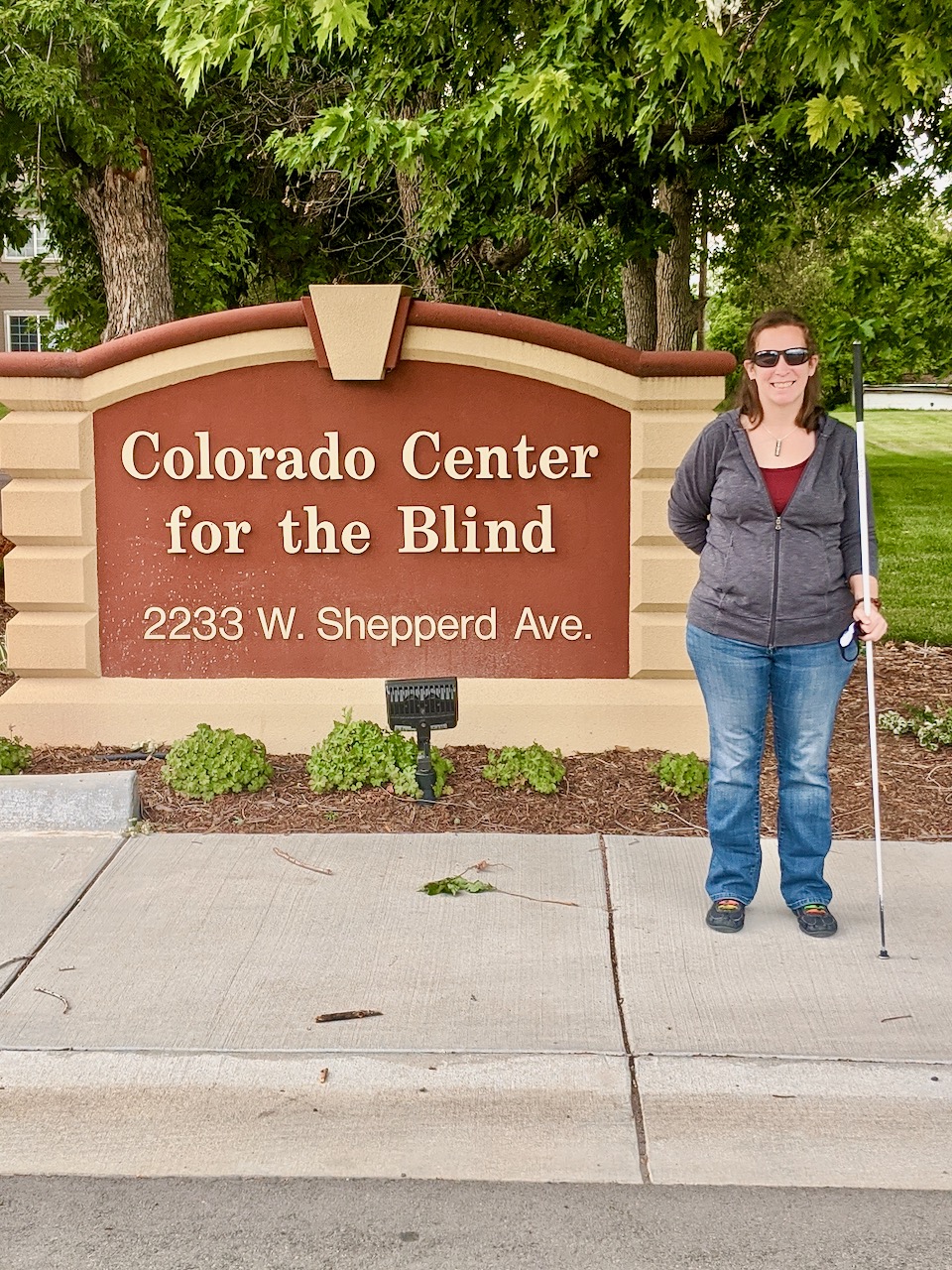 Charis standing outside next to the CCB sign