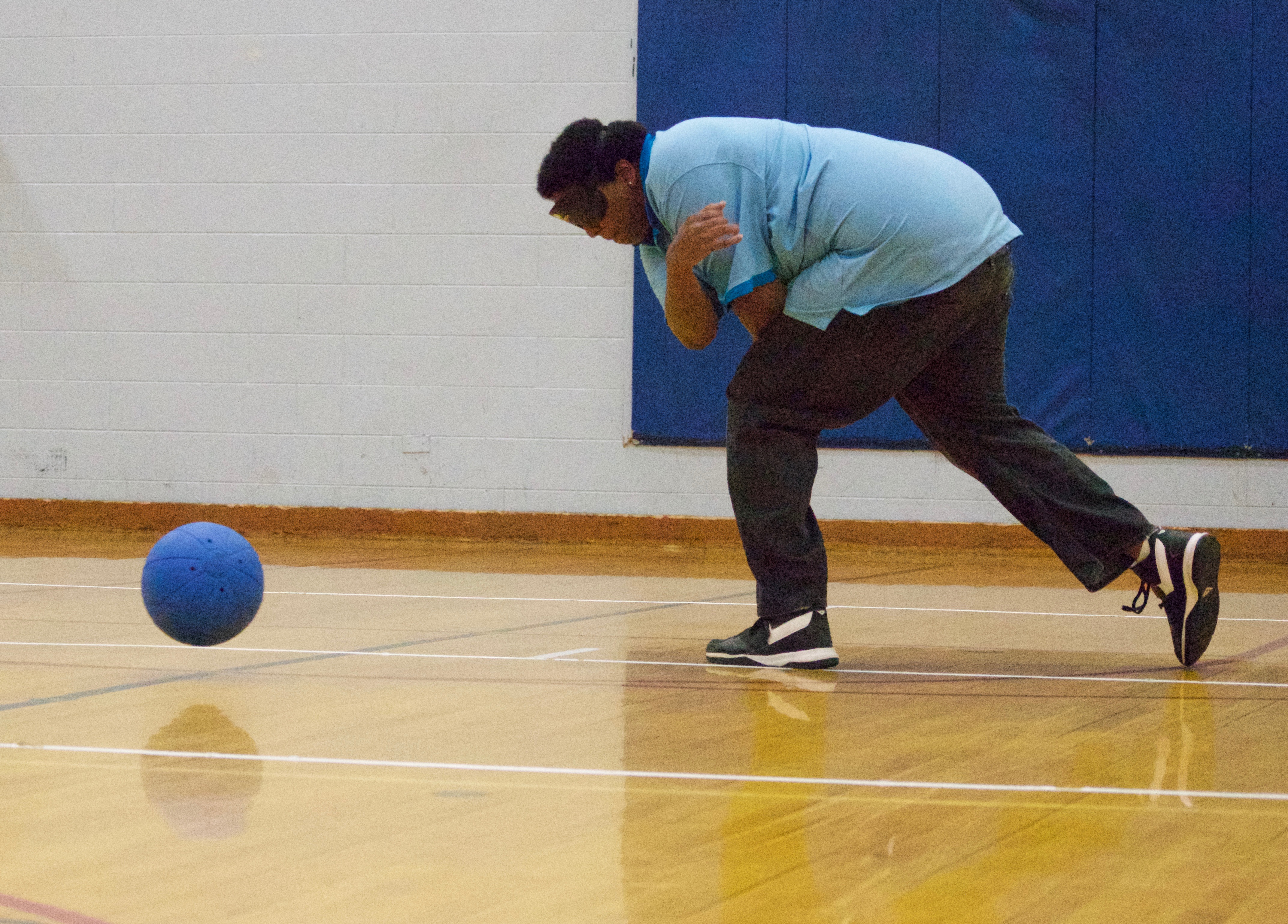 Young man demonstrates a spin throw in Goalball