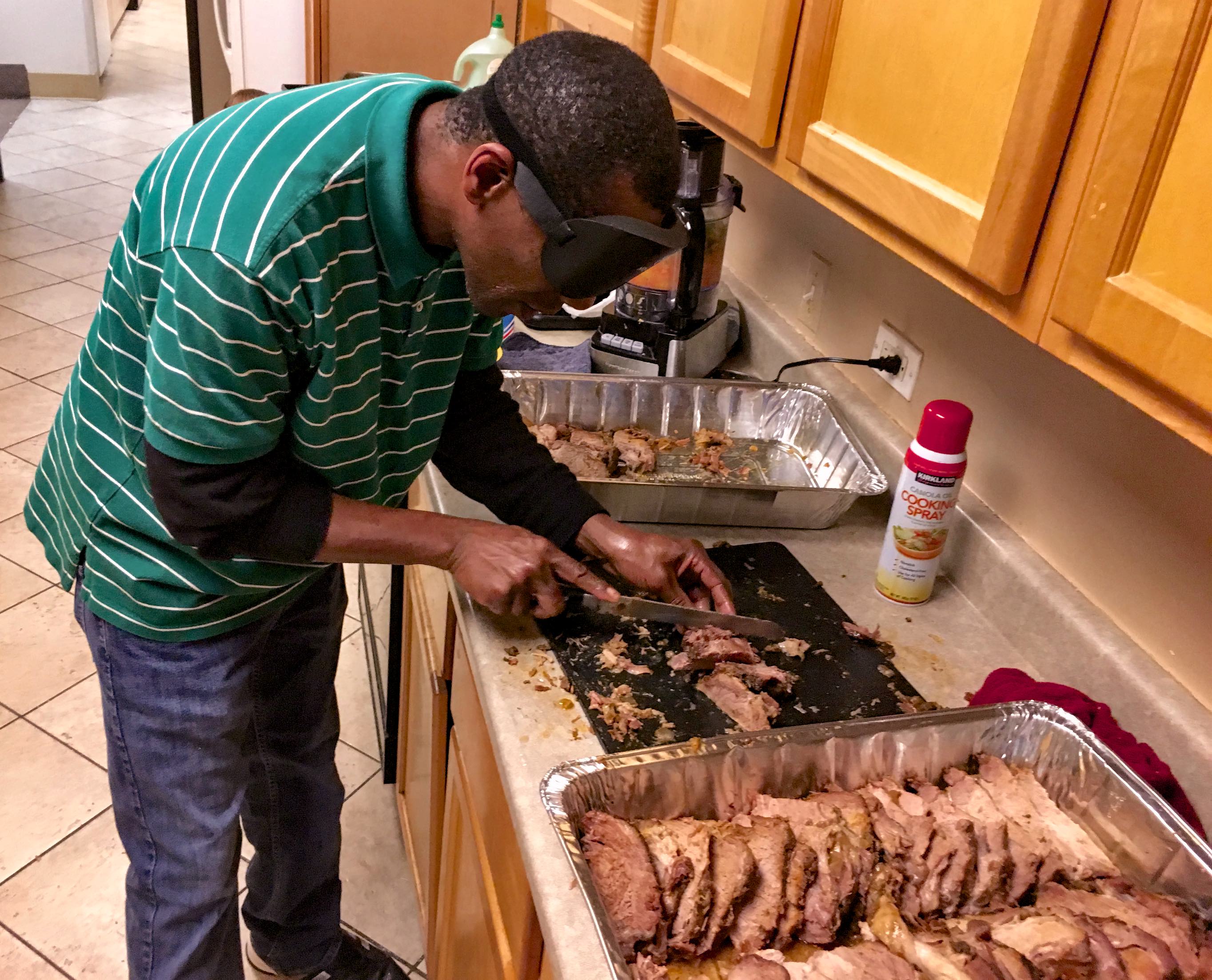 Man skillfully slices a large roast