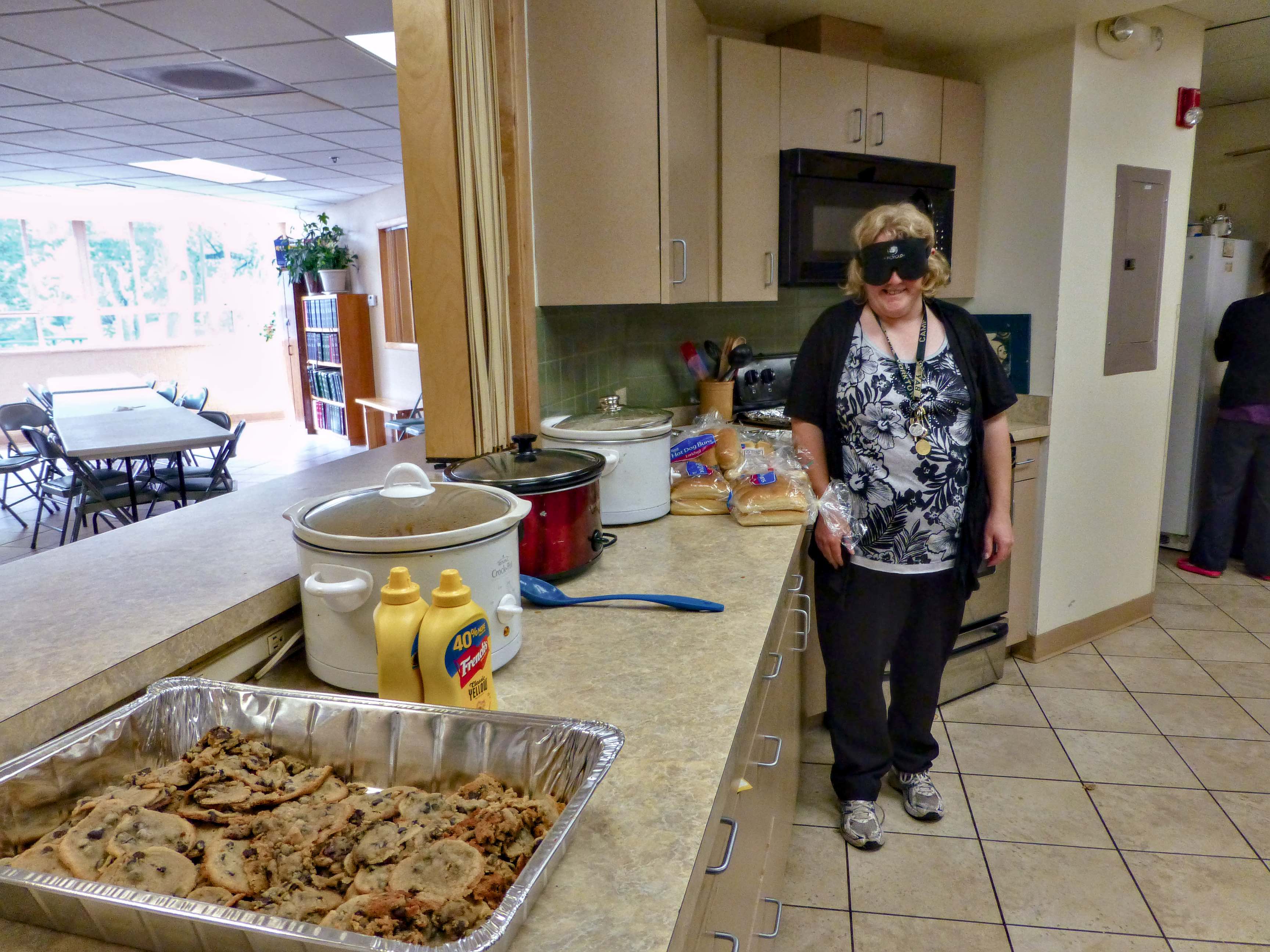 Cynthia with her graduation meal for 60 lined up inside the serving window. Her job is done at this point, and her selected servers are about to take over.