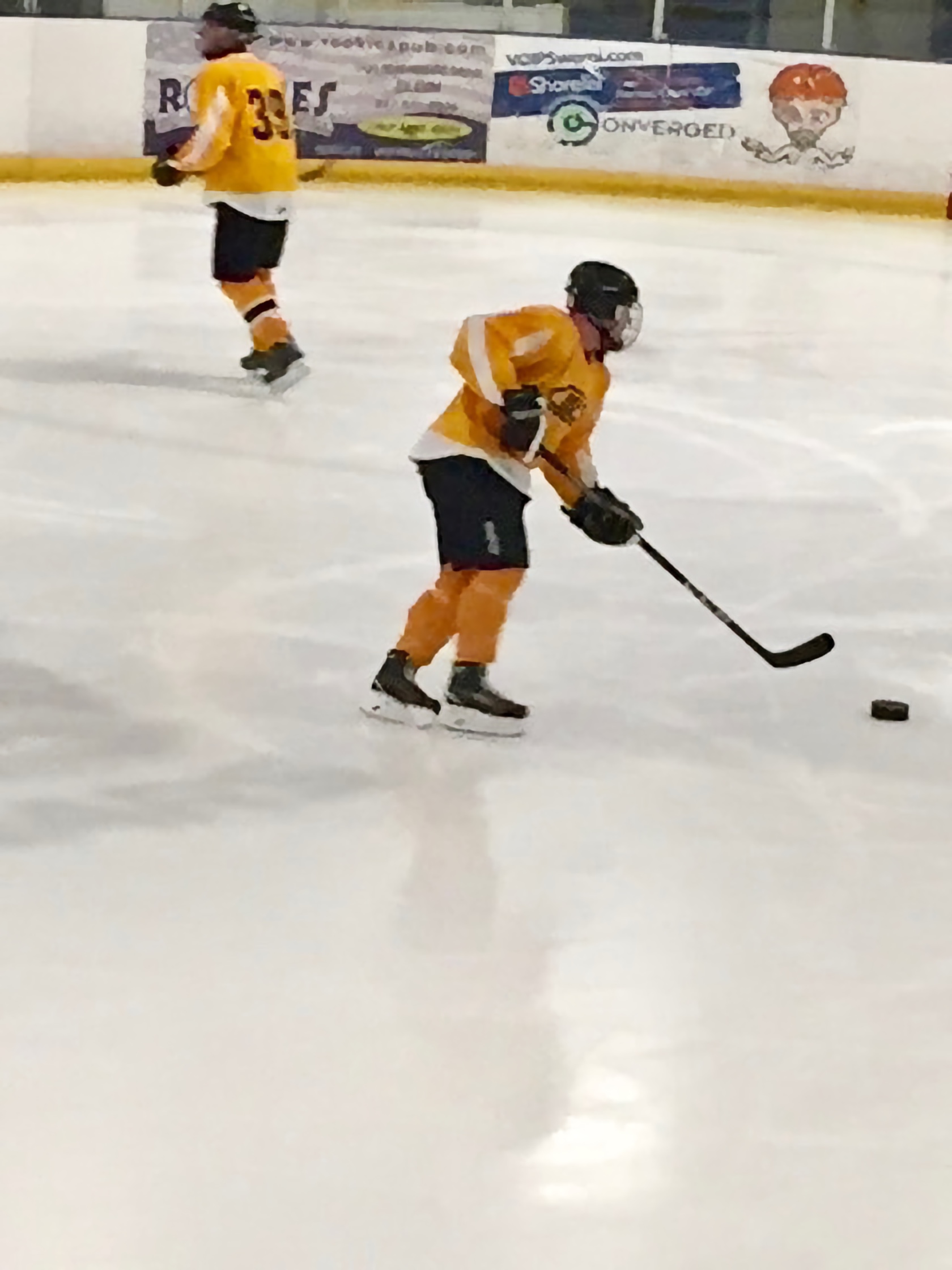 Daniel in full Hockey gear in action on the ice