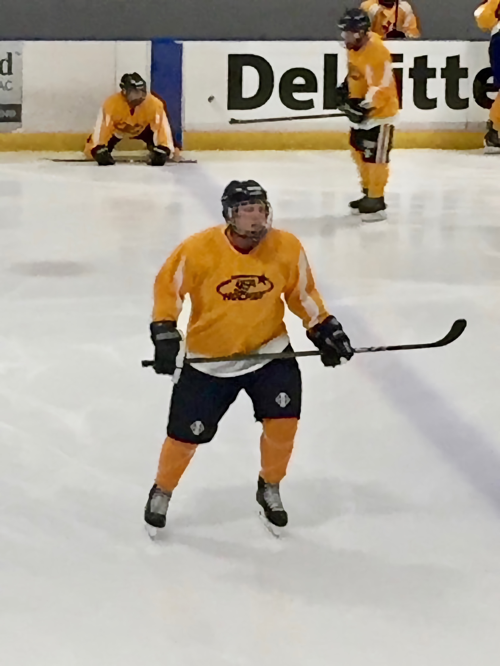Daniel in full Hockey gear in action on the ice