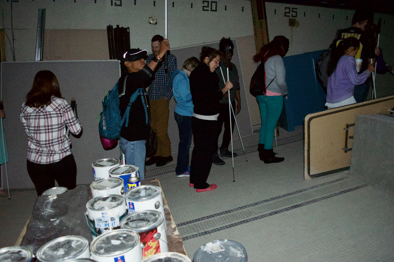 David has the students use their canes to explore the sloped floor and ceiling as they head toward the shallow end