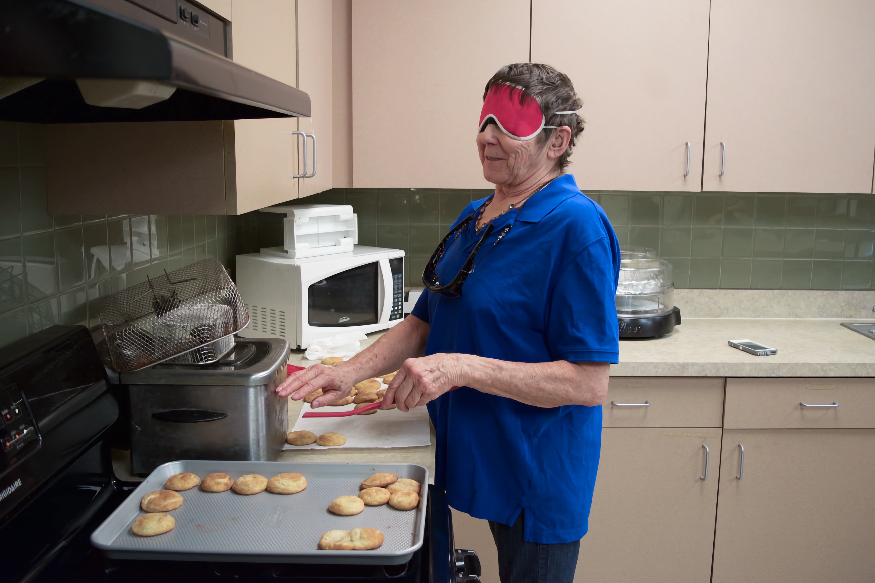 Dee works with trays of home made cookies hot out of the oven
