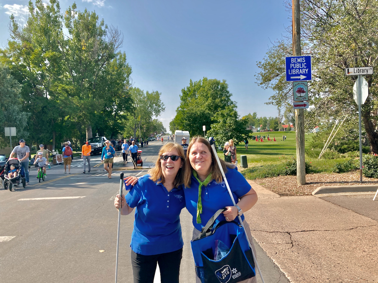 Duncan and Julie hold white canes with arms around each other’s shoulders  before the parade starts.