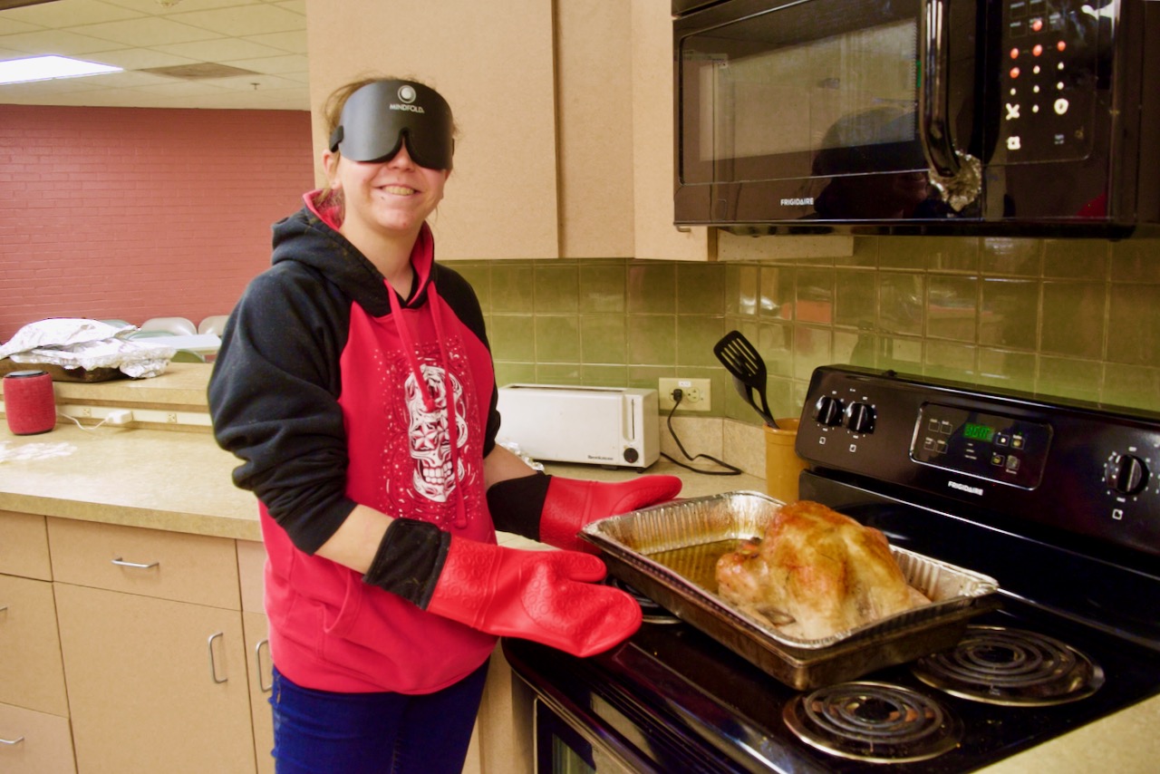 Emily with a golden-brown turkey she just took out of the oven