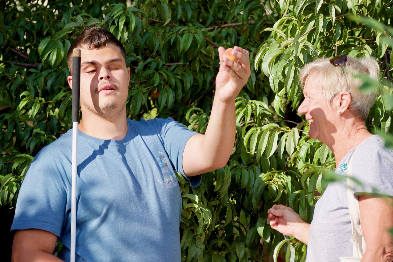 Emmitt picks Peaches from the CCB Garden