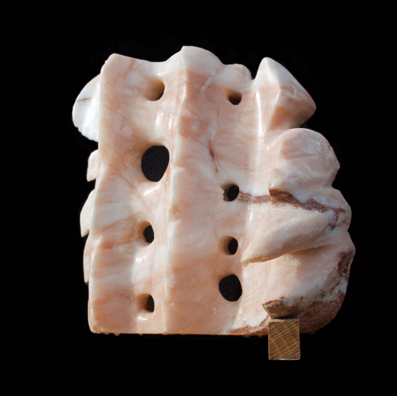 An alabaster sculpture with flowing and spiky elements “Flames and Waves”, Stone carving by Yolanda Thompson