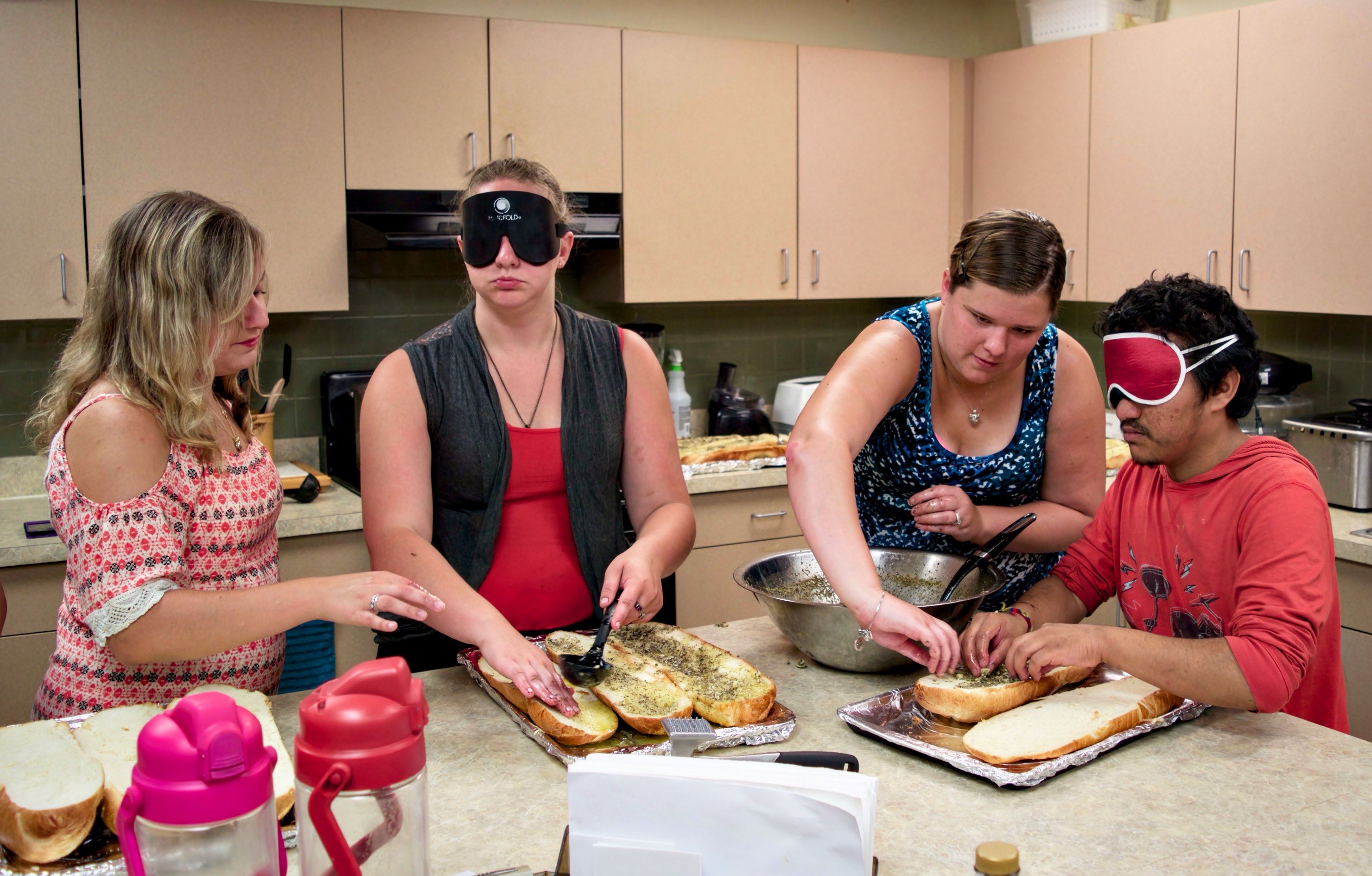 Frankie, Kaila, Brittany and Will working to season the garlic bread for the big meal