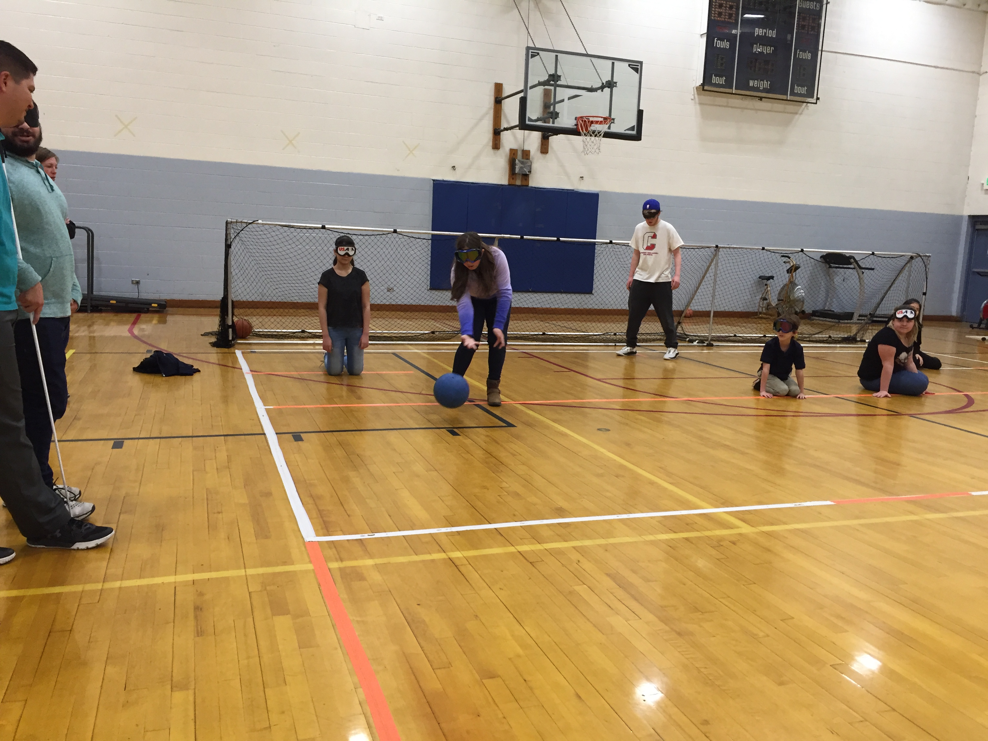 A student in sleepshades prepares to make a throw iwht the goal ball