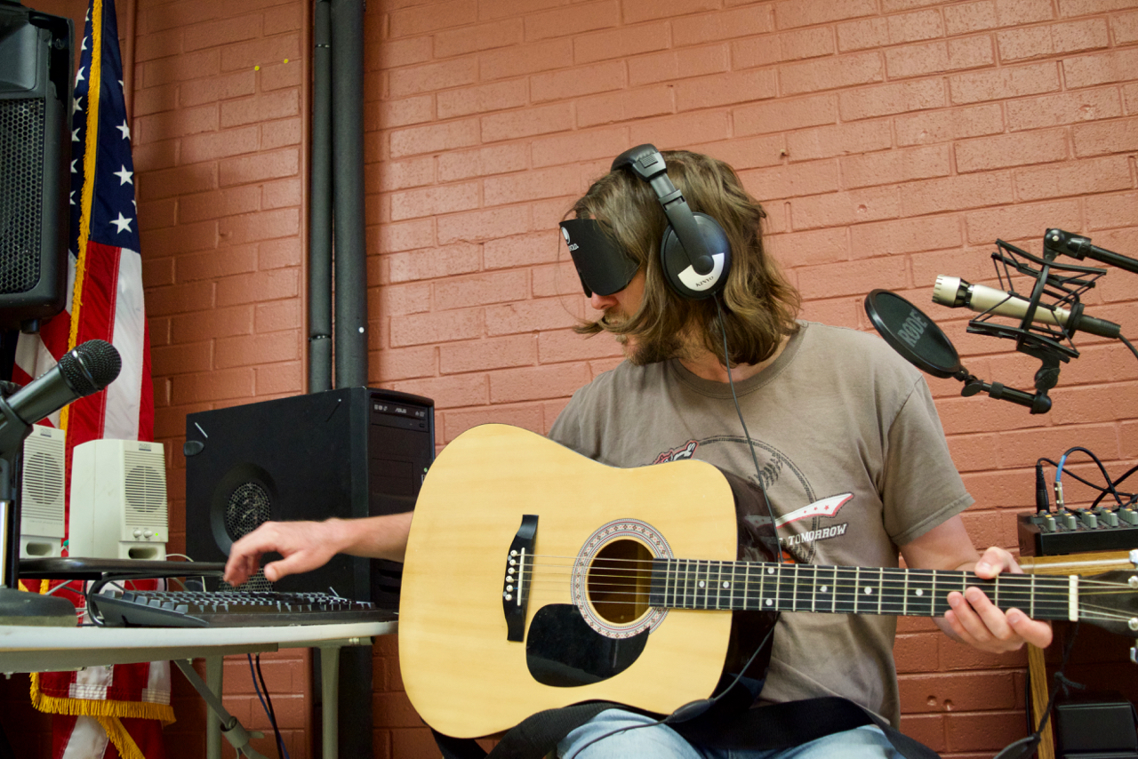 Graham wearing headphones at a PC editing tracks