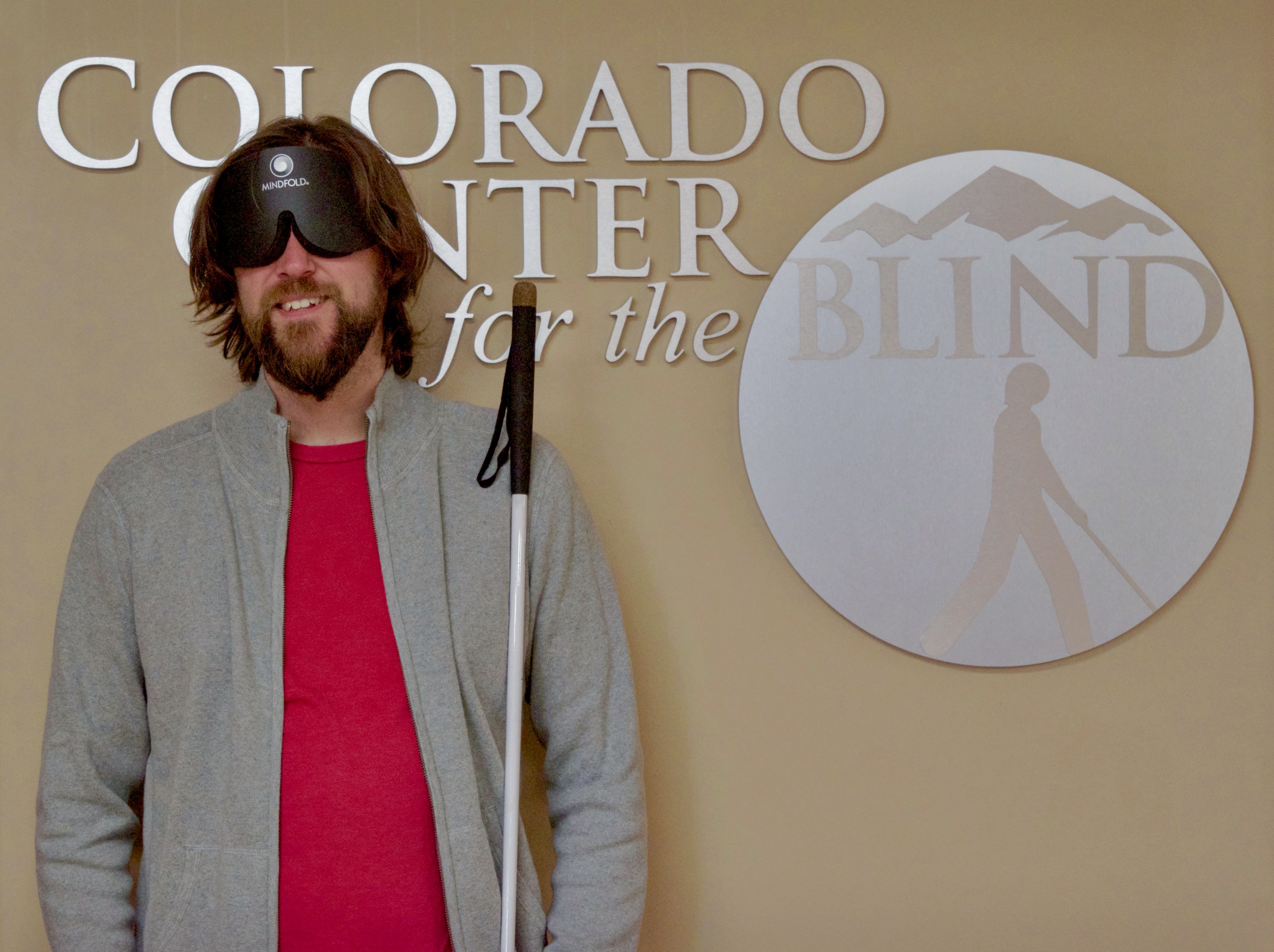 Graham standing in front of the CCB logo in the front lobby