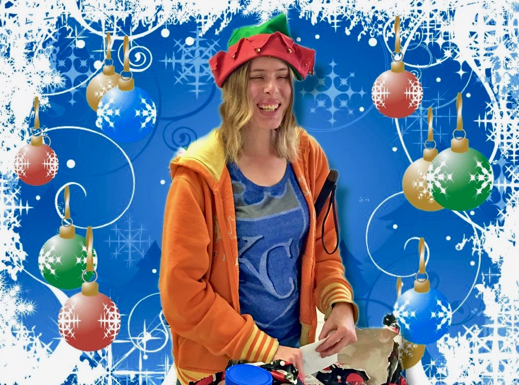 Holly wearing a festive elf hat and passing out gifts.