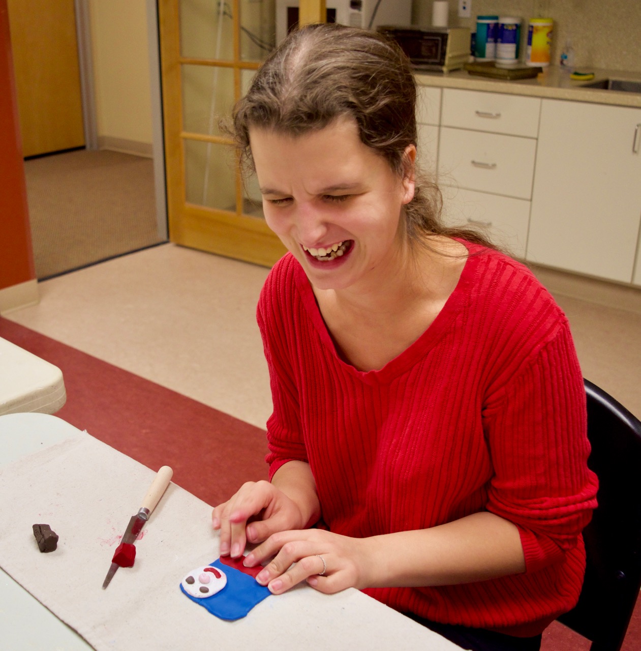 Jen is working on making a clay ornament of Thomas the Train for her son