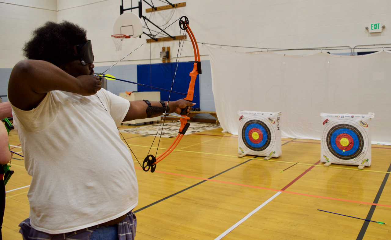 Jesse takes aim with his bow in Archery Class