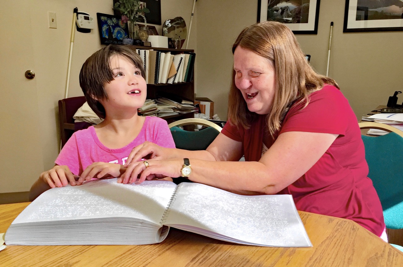 ulie and Lexi Reading Braille