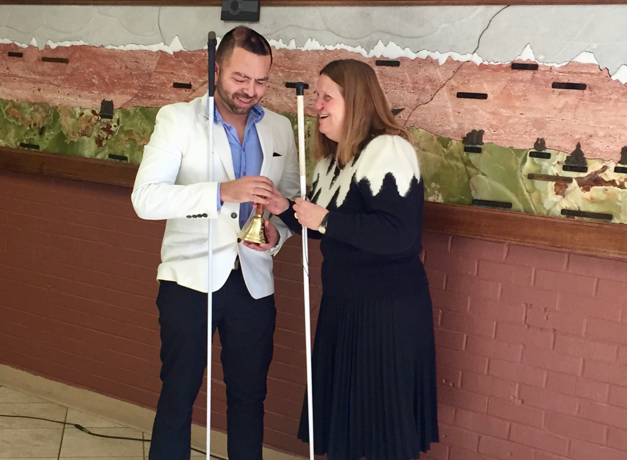 Julie handing Cesar his Freedom Bell