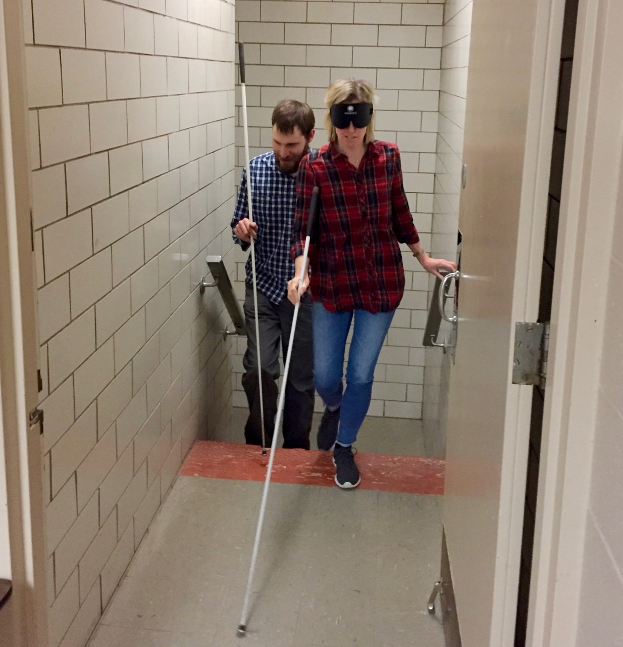 Kirsten makes her way up the west stairway with her cane and sleepshades