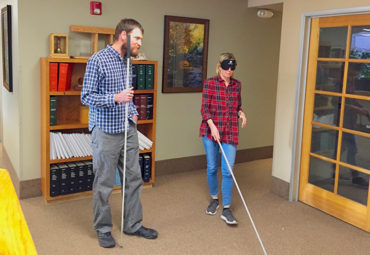 Kirsten with David working on cane travel in the front lobby