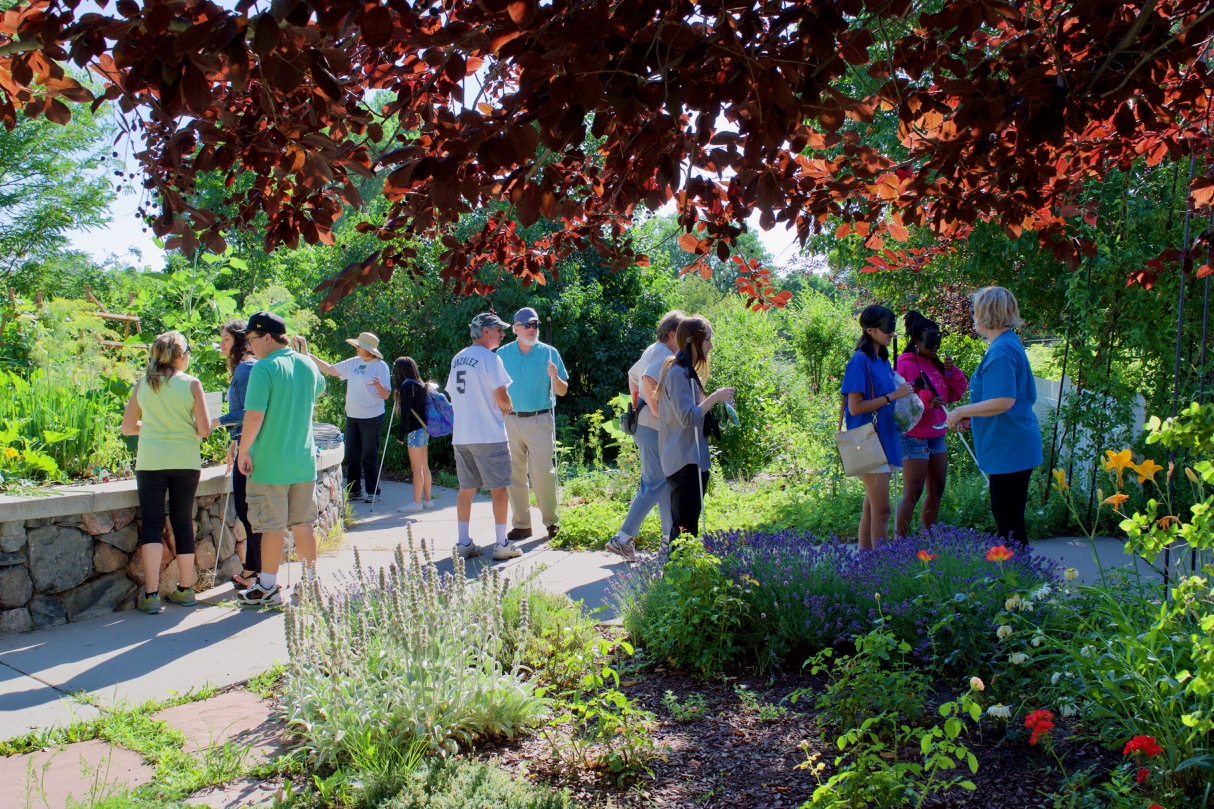 Large group of Summer Youth out in the garden with their bags full of things