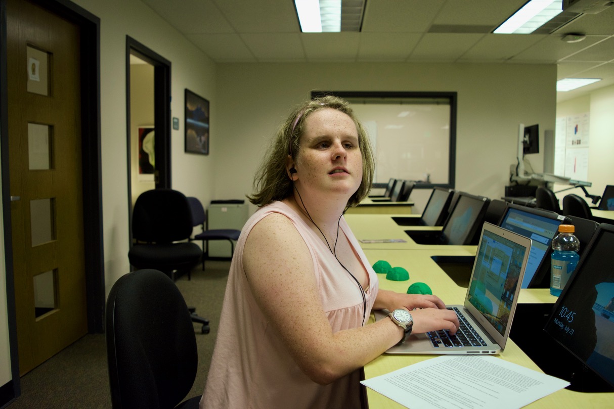 Lexi works with a laptop on components for a movie script