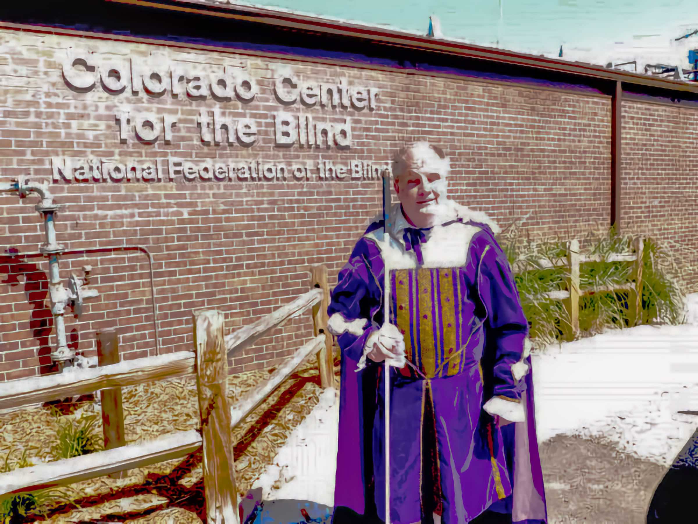Tom Anderson in a latter-day purple velvet suit beside CCB’s sign