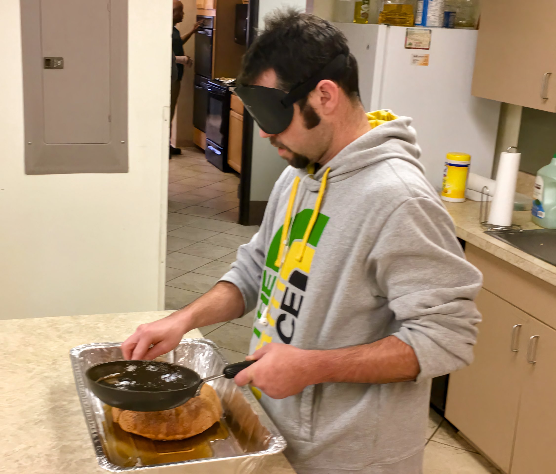 Marcus drizzles rum glaze over the cake he just made